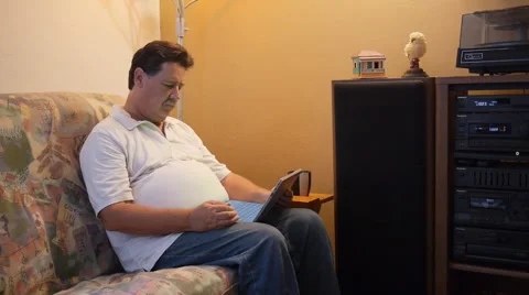 Senior professional man with tablet computer hearing music 1 Stock Footage 40728937