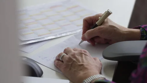 Senior Professional Writing Notes at Office Desk Stock Footage 336023976