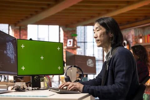 Senior programmer using chroma key computer to oversee artificial intelligence Stock Photos