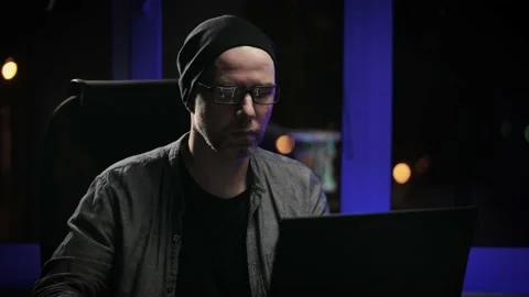 The senior programmer works late. A developer writes code for a large project. Stock Footage 173043137