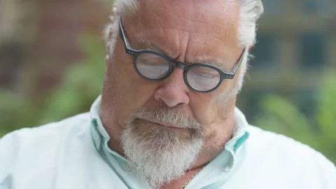 Senior retired man tilts his head up to camera and smiles Stock Footage 136446260