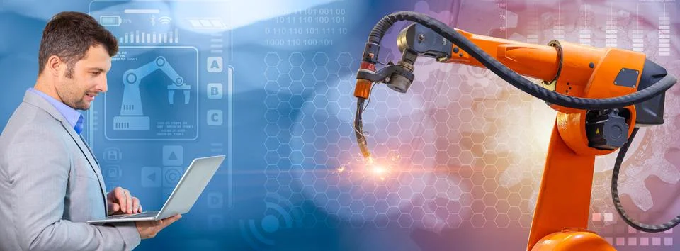 Senior robotic programmer with laptop control robot welding arm for new gener 스톡 사진