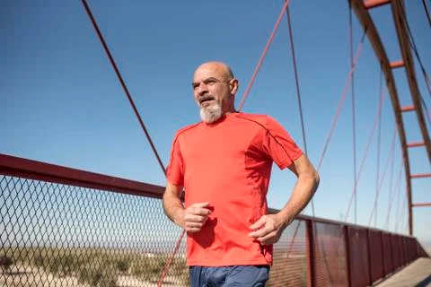 Senior runner training on a bridge Stock Photos