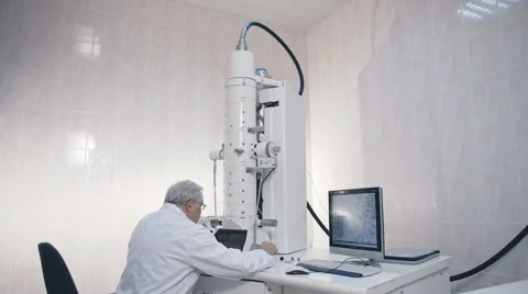 Senior scientist doing research in laboratory equipment electron microscope Stock Footage 58666933