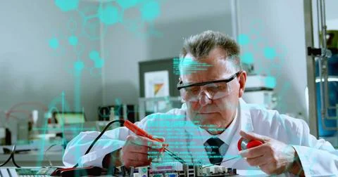 Senior scientist in lab coat testing circuit board at lab, with red black 스톡 사진