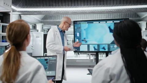Senior scientist in lab presents innovative DNA sequencing project to colleagues Stock Footage 327099013