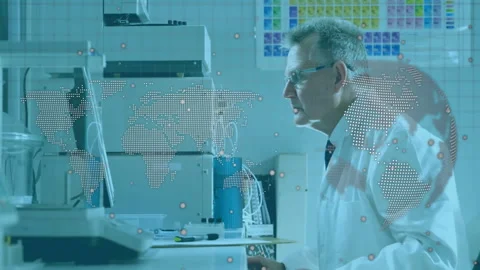 Senior scientist loading sample into analyzer for testing while monitoring world Stock Footage 311140711