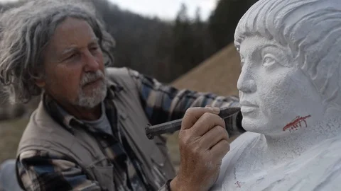 Senior sculpting in a stone with chisel Video stock 104577987