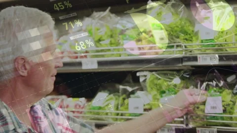 Senior shopper reaching bagged lettuce in retail, checking freshness with Stock Footage 321319428