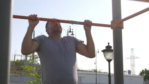 Senior sporty man doing pull ups on horizontal workout outdoors Stock-Footage 143505321