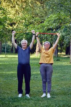Senior spouses doing exercises using resistance rubber bands Stock Photos