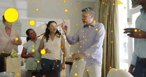 Senior starting speech, guests toasting, laughing at social dinner, particles Stock Footage 330894741