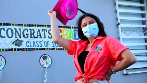 Senior Student with Facemask, Throwing Graduation Hat Upwards Stock Footage 130478520