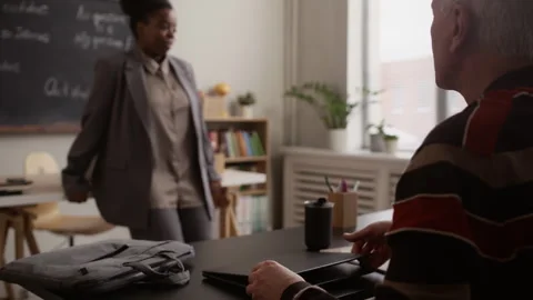 Senior Student Opening Laptop while Listening to Teacher Stock Footage 329284340