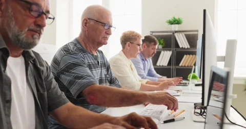 Senior students at computers in classroom during adult education training Stock Footage 341331483
