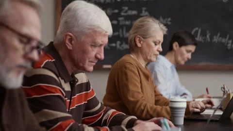 Senior Students Engaged with Laptops in Classroom Setting Stock Footage 329285541