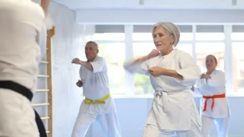 Senior students perform basic movements and repeat to hold pose, learning Stock Footage 341426694