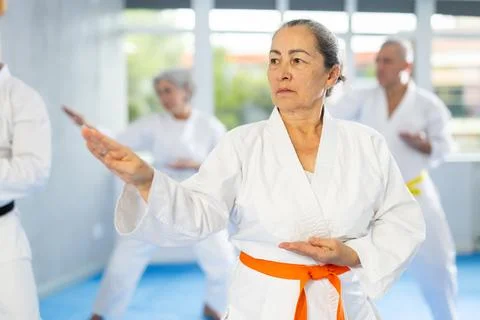 Senior students perform basic movements and repeat to hold pose, learning Foto stock