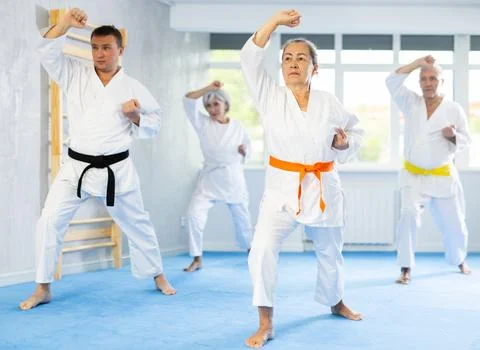 Senior students perform basic movements and repeat to hold pose, learning Stock Photos