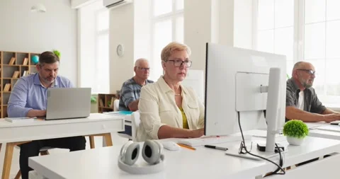 Senior students practicing computer skills in adult education class on desktops Stock Footage 341630792