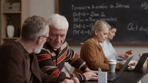 Senior Students Using Laptops in Classroom with Chalkboard Stock Footage 329294044