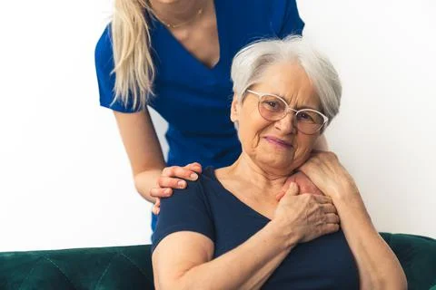 Senior support concept. Elderly gray-haired caucasian lady being supported by a Stock Photos