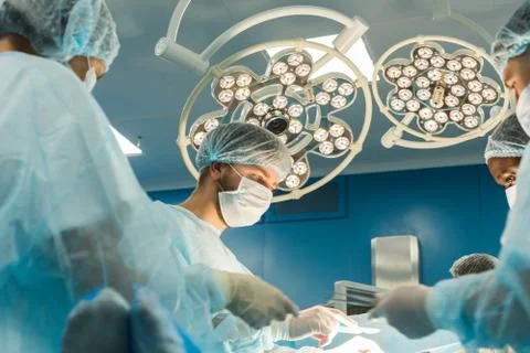 The senior surgeon in the operating room, where the patient is waiting for him Stock Photos