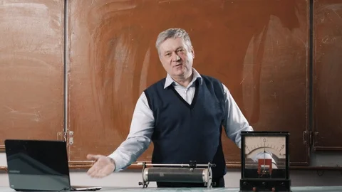 Senior teacher explains lesson, talking with students and writing Stock Footage 102855253