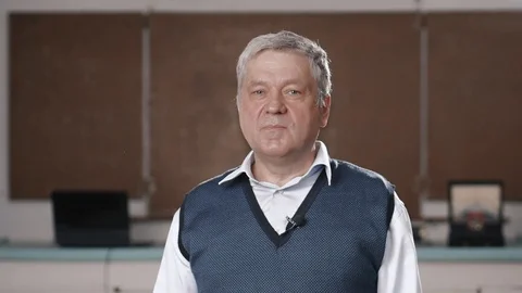 Senior teacher talking into camera as if being interviewed Stock Footage 102836270