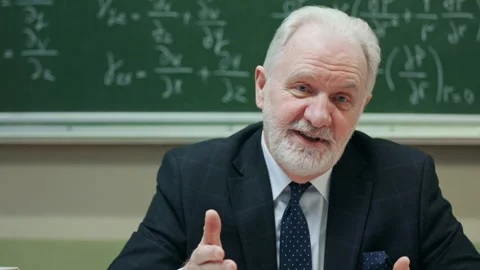 Senior teacher talks with students explains math formulas during lesson Stock Footage 151830100