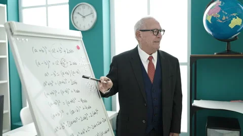 Senior teaching maths on magnetic board at university classroom Video stock 233399473