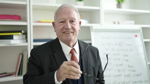 Senior teaching standing by white board at street Stock Footage 233399411