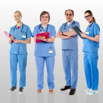 Senior team of doctors posing with a smile Stock Photos