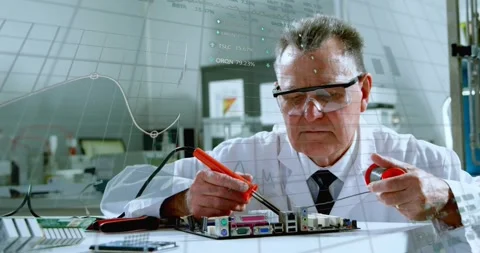 Senior tech placing board, soldering in tech lab while data graphs aligning with Stock Footage 330717899