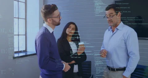 Senior technology lead pointing at screen and showing code snippet overlay while Stock Footage 311216358