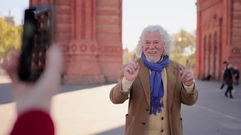 Senior tourist man smiling while his wife taking photos Stock Footage 262604301