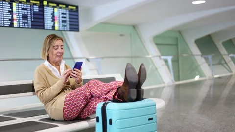 Senior Tourist Using Smartphone While Waiting at the Airport Stock Footage 300858984