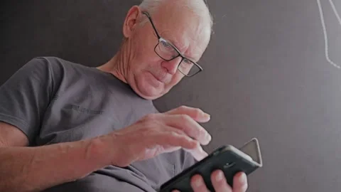 Senior Using Smartphone to Access Digital Services and Modern Technology Stock Footage 337930876