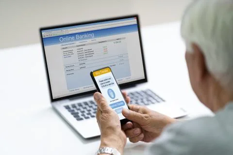 Senior Using Two Factor Online Bank Authentication Stock Photos