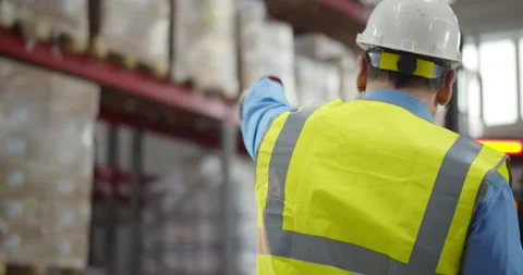 Senior warehouse manager using walkie-talkie at workplace Stock Footage 151405974