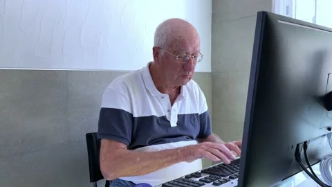 Senior white man with good computer skills, writing fast on the keyboard Stock Footage 196488163