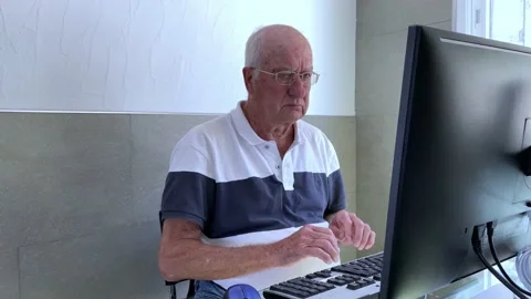 Senior white man struggling with computer because of missing PC skills Stock Footage 196486485