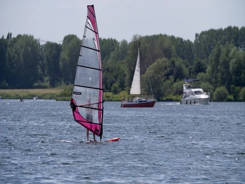 Senior wind surfer passing ships and son Stock Footage 76540032