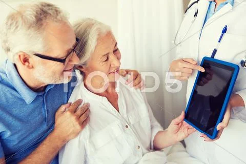 Senior woman and doctor with tablet pc at hospital Stock Photos