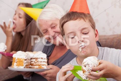 Senior woman and its grandsons with birthday cake Stock Photos