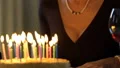 Senior woman blowing out candles on cake, surprise for birthday anniversary HD Footage
