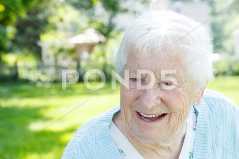 Senior woman in a blue sweater outside Stock Photos