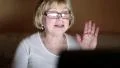 Senior woman communicates using laptop. Woman with notebook HD Footage