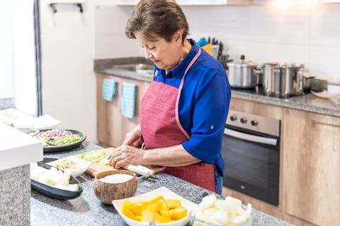 Senior Woman Cooking in the Kitchen Stock Photos