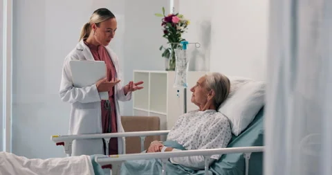 Senior woman, doctor and clipboard by hospital bed for report, good news or Stock Footage 310790475